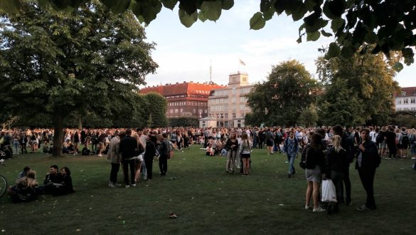 Pessoas aproveitando o fim de tarde no jardim do Castelo Rosenborg, em Copenhagen, Dinamarca.